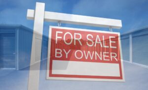 For sale by owner sign over self-storage units
